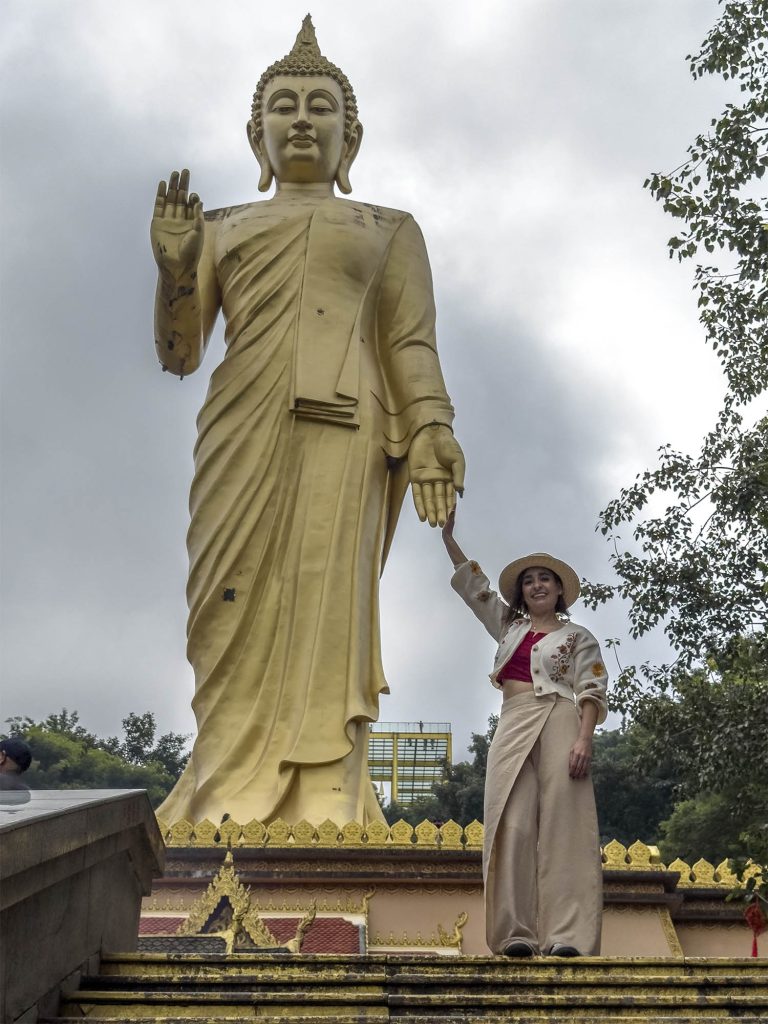 Marta posando junto a la estatua del Gran Buda de 49 metros de Mengle, en Xishuangbanna, China
