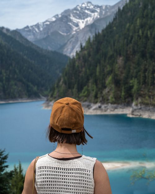 Vista panorámica de Long Lake (长海) en Jiuzhaigou, el lago más grande y profundo del parque, con sus aguas de un intenso azul turquesa en forma de media luna rodeado de picos nevados de la cordillera Minshan.